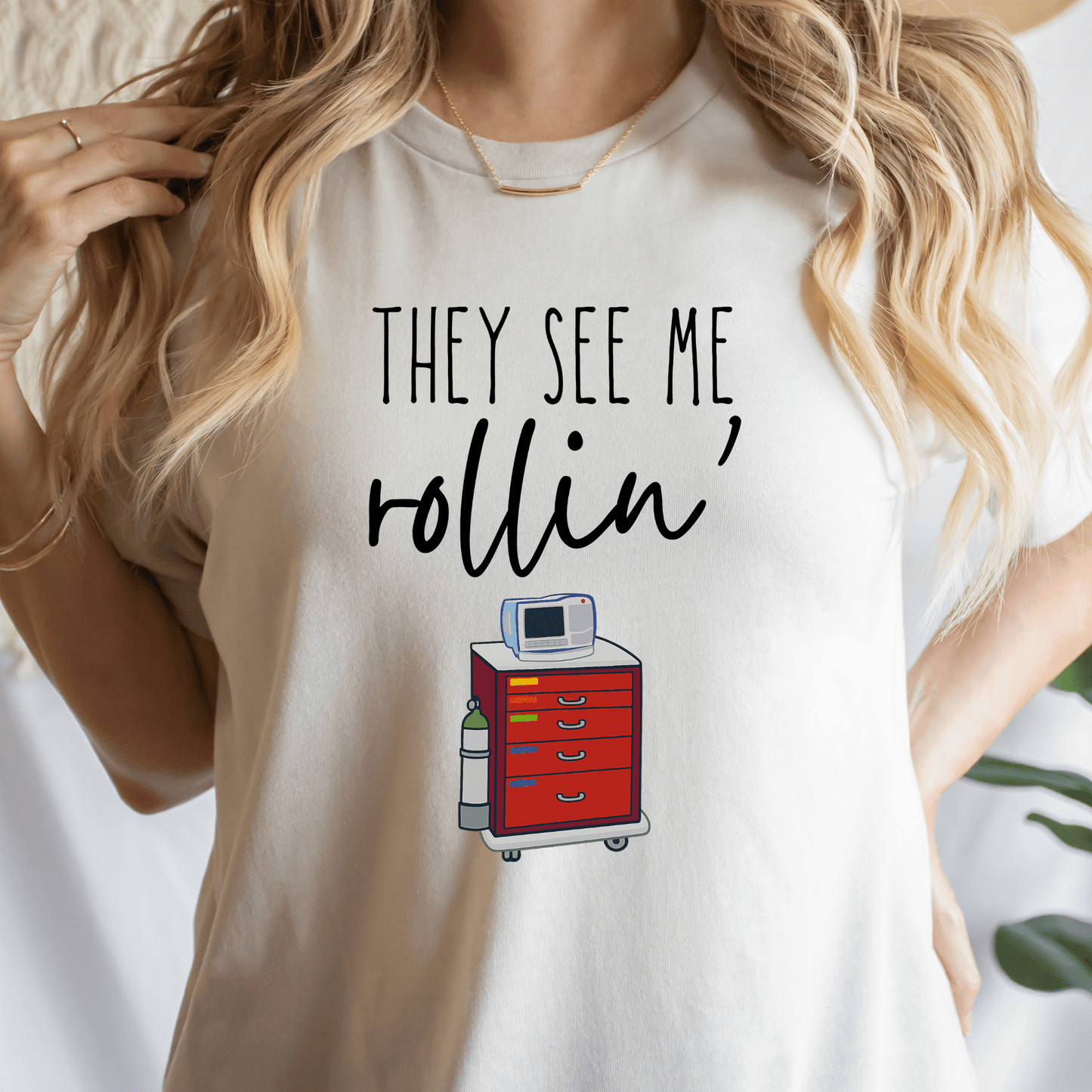 Funny Nurse T-Shirt – "They See Me Rollin’" Crash Cart Design | Medical Scrub Life Tee for Healthcare Workers, RNs, & EMTs Sand